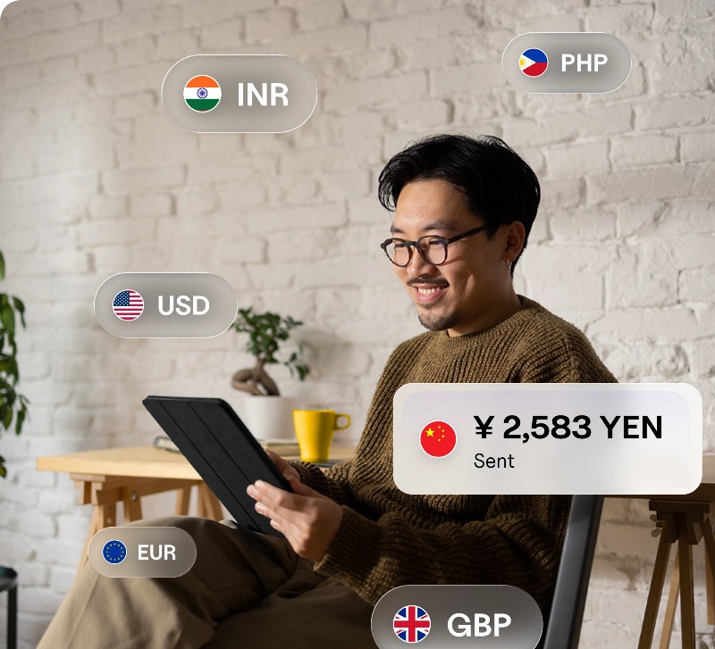 Man engaged with a tablet showing currency symbols